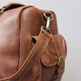 Leather holdall zip top travel bag with strap and side pockets